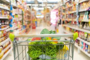 grocery cart pointing down a grocery aisle