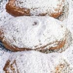 Powdered sugar beignets on a tray