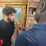 Man lighting cigar in tobacco shop