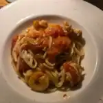 Spaghetti with shrimp and tomatoes on plate