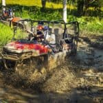 ATV driving through muddy terrain adventure