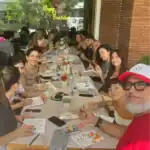Group of people at a drawing workshop, smiling.