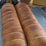 Two fresh loaves of bread on a tray