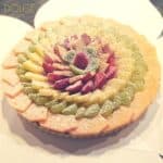 Colorful fruit tart with powdered sugar topping.
