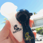 Person holding two contrasting High Life pipes.