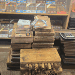 Stacked cigar molds and boxed cigars in shop.