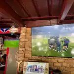 Sports bar with multiple TVs showing soccer games.