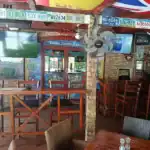 Sports bar interior with TVs and license plates decor.