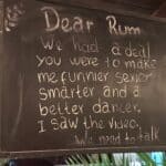 Humorous chalkboard message about rum's effects.