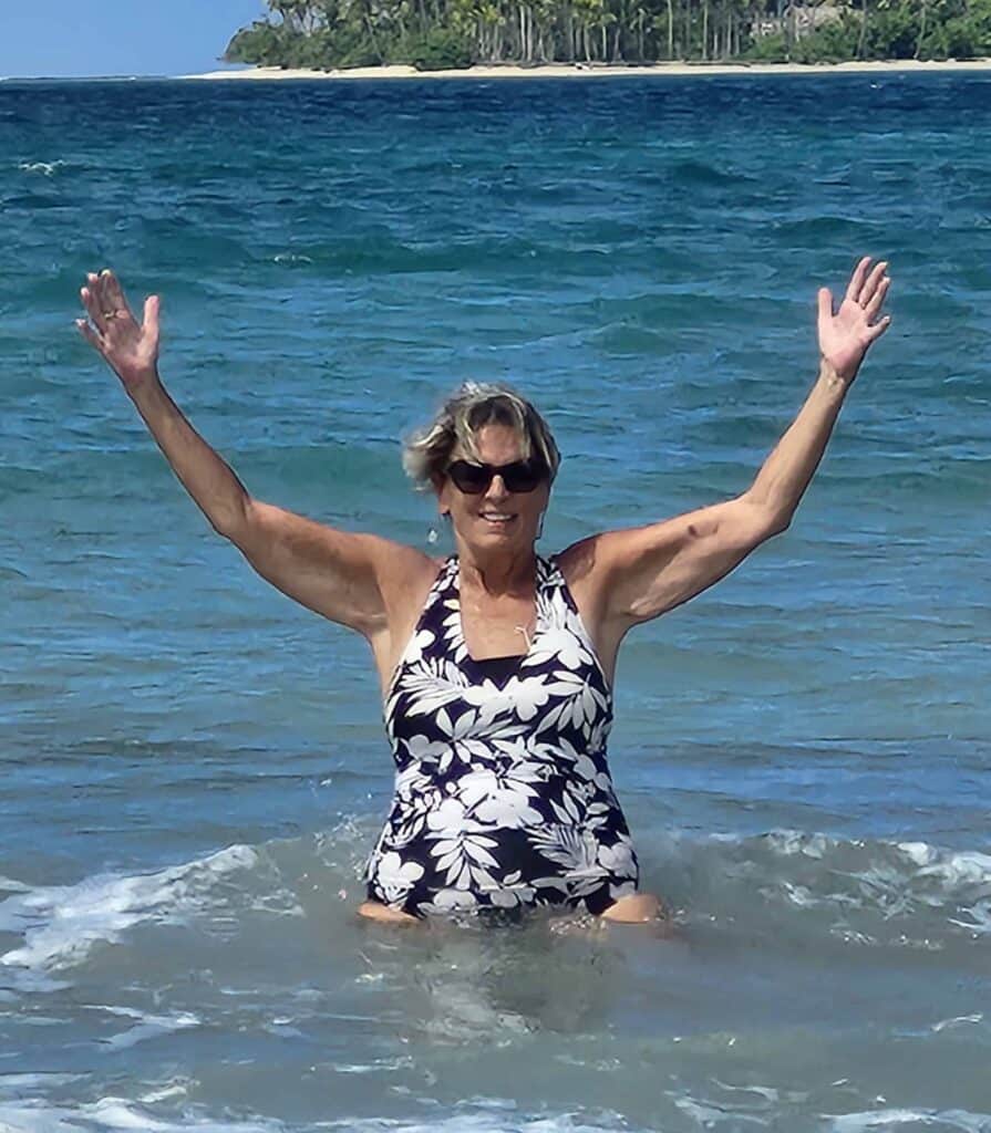 Woman enjoying ocean waves on tropical beach