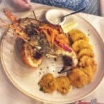 Grilled lobster with plantains and dipping sauce.
