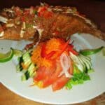 Fried fish with vegetables and lime slices