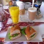 Sandwiches with drinks on a cafe table.
