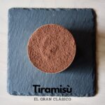 Tiramisu dessert on slate plate, top view.