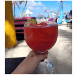 Refreshing red cocktail by the beach