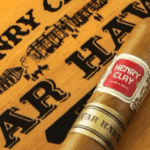 Henry Clay cigar on wooden box.