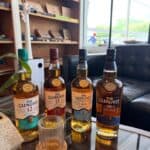 Four Glenlivet whiskey bottles on a table.