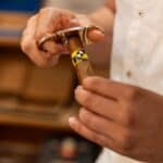Person cutting a cigar with a guillotine cutter.