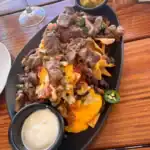 Loaded beef nachos with cheese and guacamole.