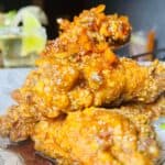 Close-up of spicy fried chicken wings on plate.