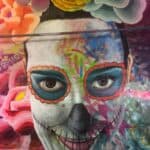Colorful mural of a face with floral elements.