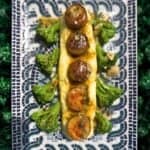 Stuffed zucchini with mushrooms and broccoli on plate.