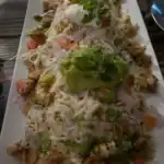 Plate of loaded nachos with toppings