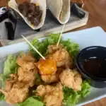 Fried chicken and BBQ beef tacos with dip.