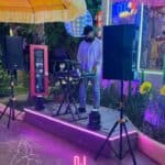 DJ performs at outdoor restaurant event.