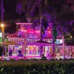 Colorful nighttime restaurant with purple lighting and decorations.