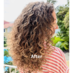 Woman with curly hair and striped shirt.