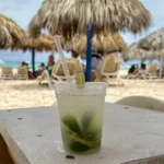 Refreshing lime drink on tropical beach table