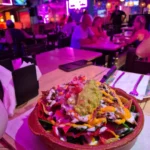 Colorful nachos with guacamole in vibrant restaurant