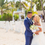 Couple getting married on a sunny beach.