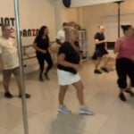 Group dance class at fitness studio.